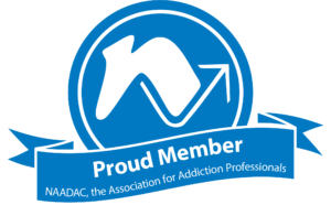 A blue and white badge with the NAADAC logo above a banner that reads "Proud Member NAADAC, the Association for Addiction Professionals," reflecting our commitment to behavioral health in Philadelphia PA.