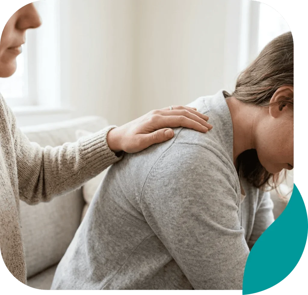 Woman comforting an upset friend with a hand on her shoulder